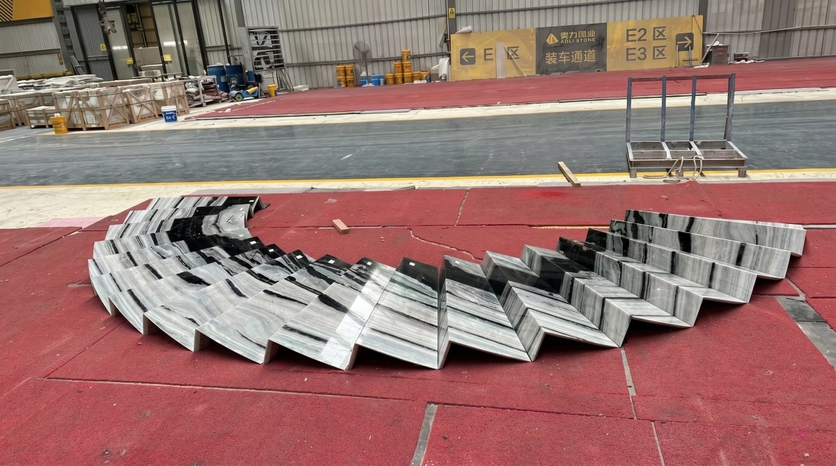 Boutique hotel staircase project featuring bold linear grey black and white marble