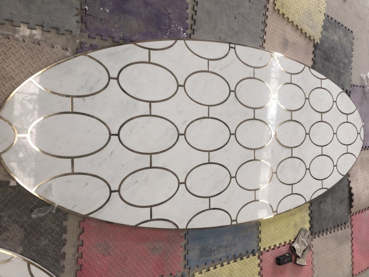 Aoli Stone custom white marble casino floor medallions with brass inlay during factory pre-assembly