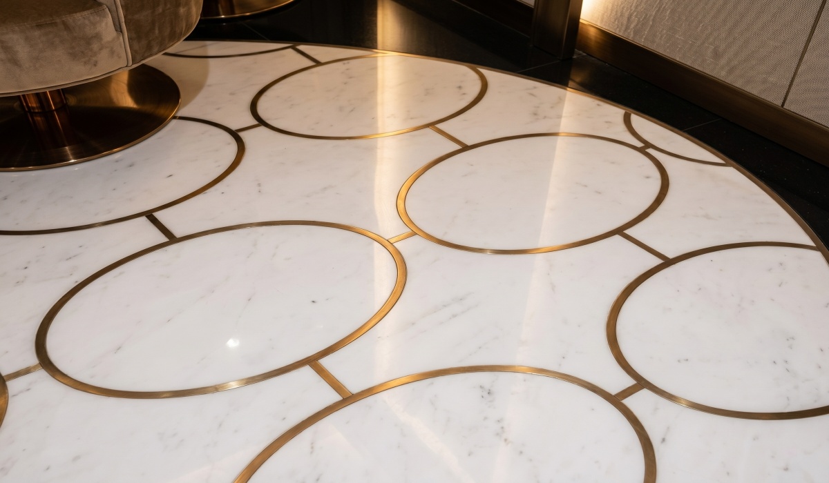 marble floor medallion with repeated brass inlay pattern