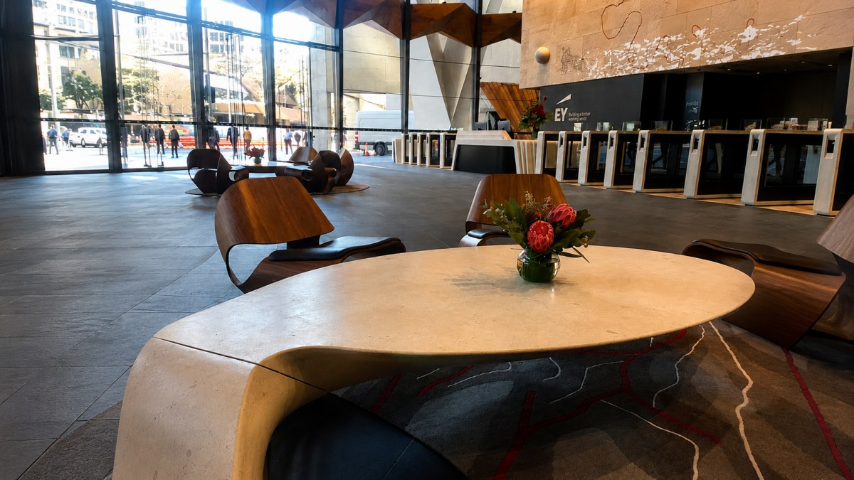 Custom French limestone sculptural table used in a commercial lobby interior 