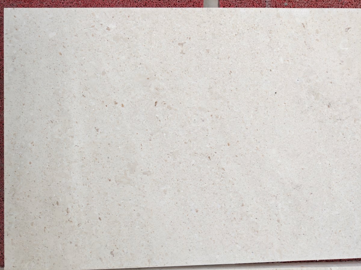 Close-up view of Cotswold Cream Limestone honed surface with fossil texture and soft beige tone