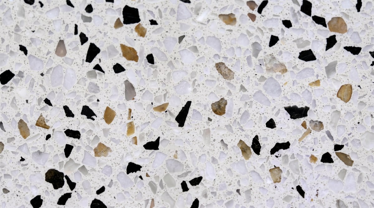 Close-up of terrazzo surface showing aggregate distribution and chip size under realistic factory lighting