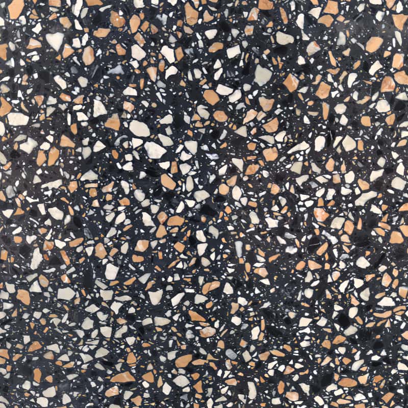 Close-up of Amber Night Black Terrazzo slab with mixed white, grey and warm amber natural stone aggregates